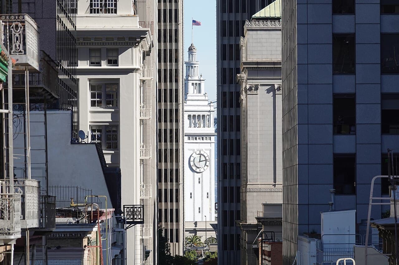The Ferry Building clock tower seen at the end of Commercial Street, between Financial District office towers