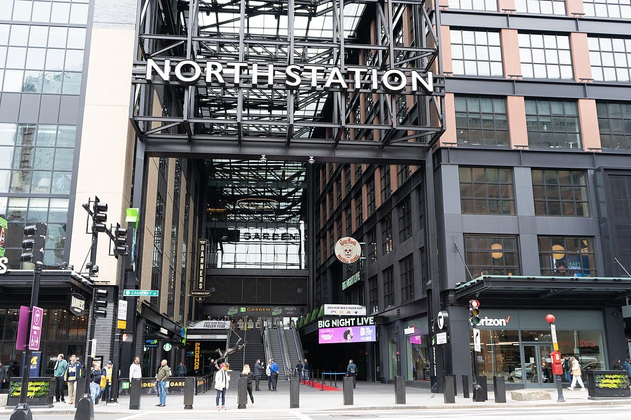 The North Station entrance on Causeway Street in Boston, with the station's name on a steel frame above the escalators