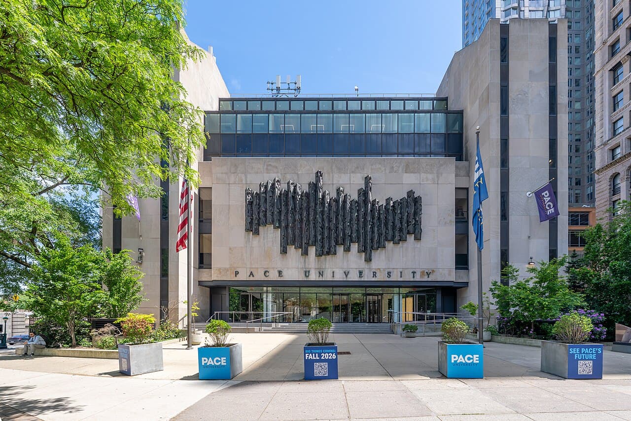 The plaza in front of Pace University's One Pace Plaza building in Lower Manhattan, with blue Pace planters and flags