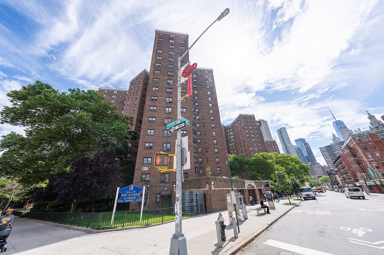 The brick towers of the Alfred E. Smith Houses in Two Bridges, with Lower Manhattan's skyline to the right