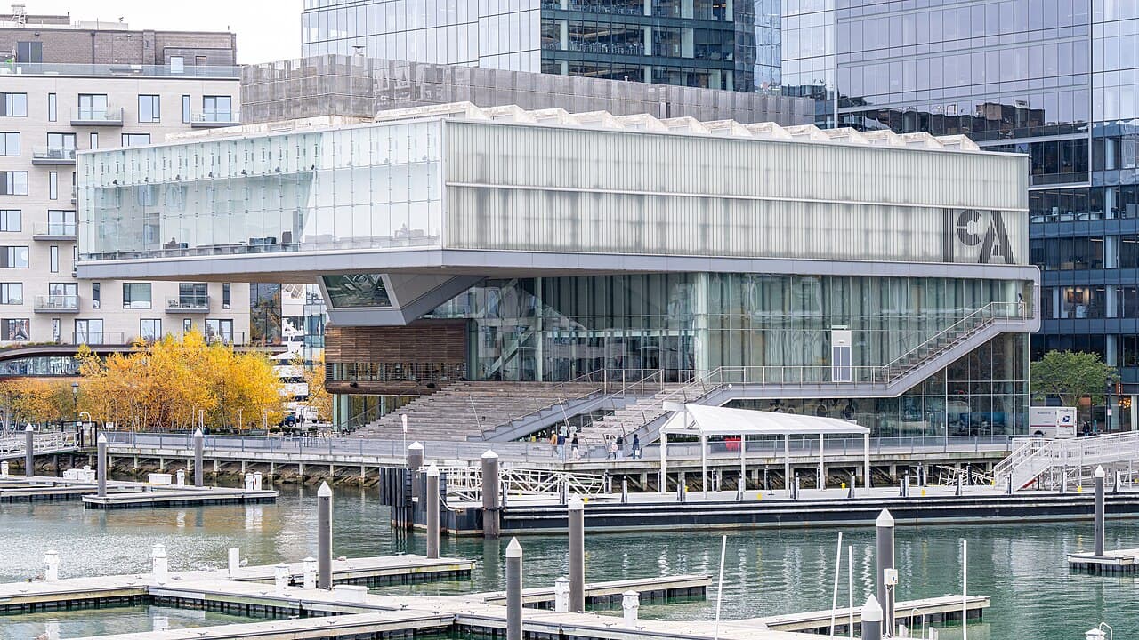 The glass and steel Institute of Contemporary Art building on the Seaport waterfront, with boat docks in front of it