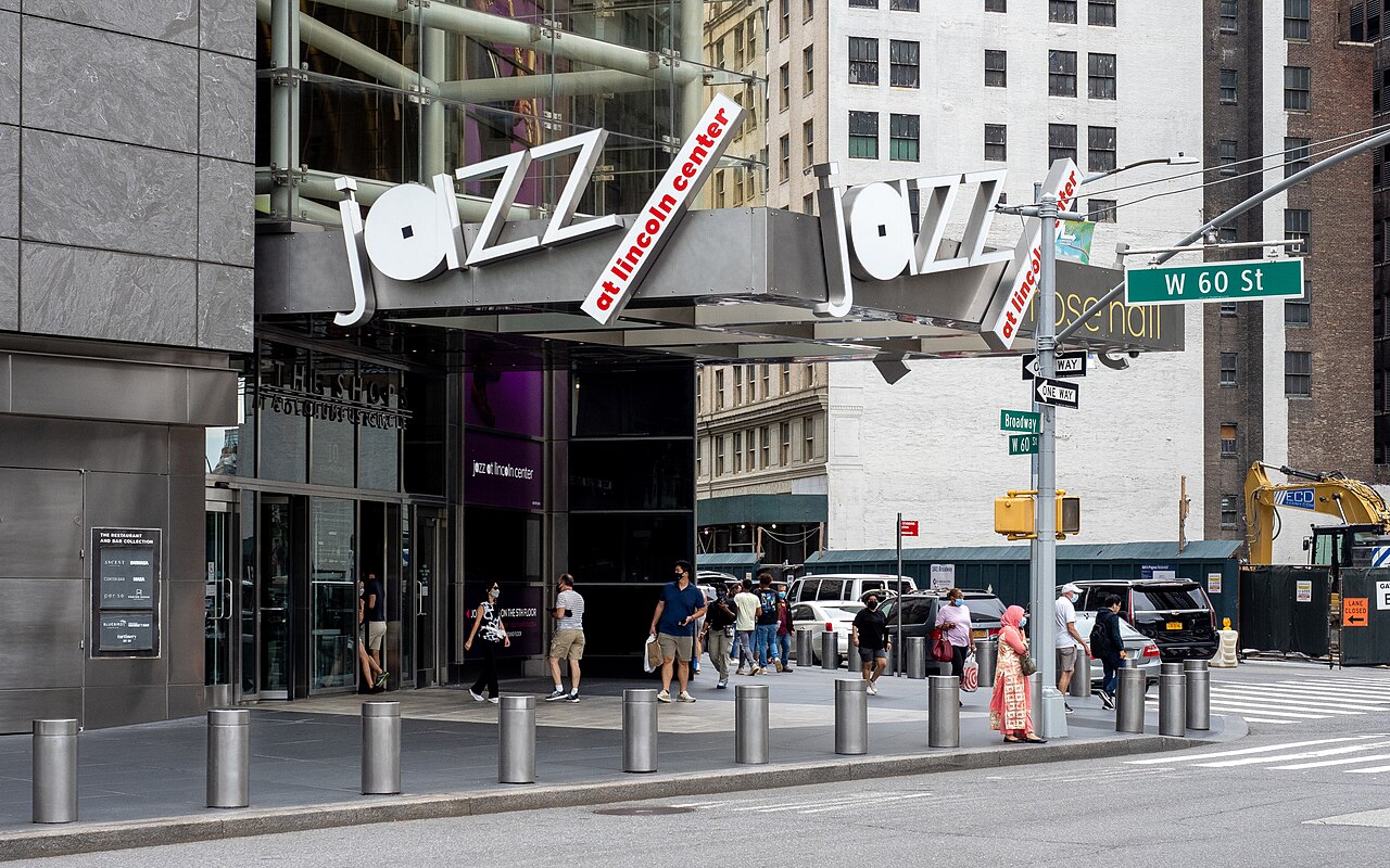 The Jazz at Lincoln Center sign over its entrance at Broadway and West 60th Street, with people walking past