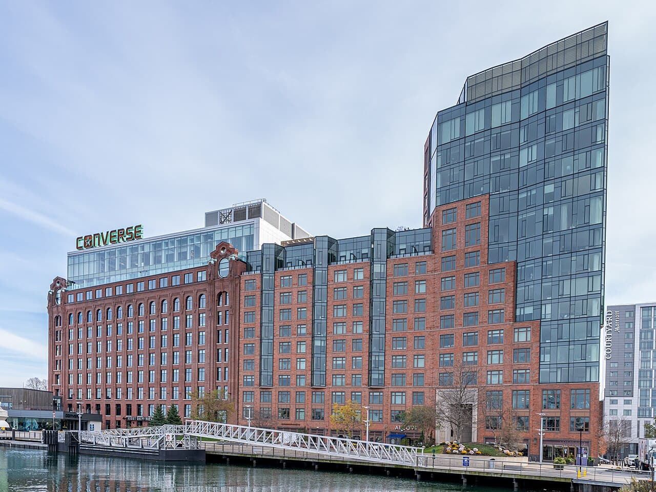 The red brick Lovejoy Wharf buildings beside the water near North Station in Boston, with a Night Shift Brewing sign at street level