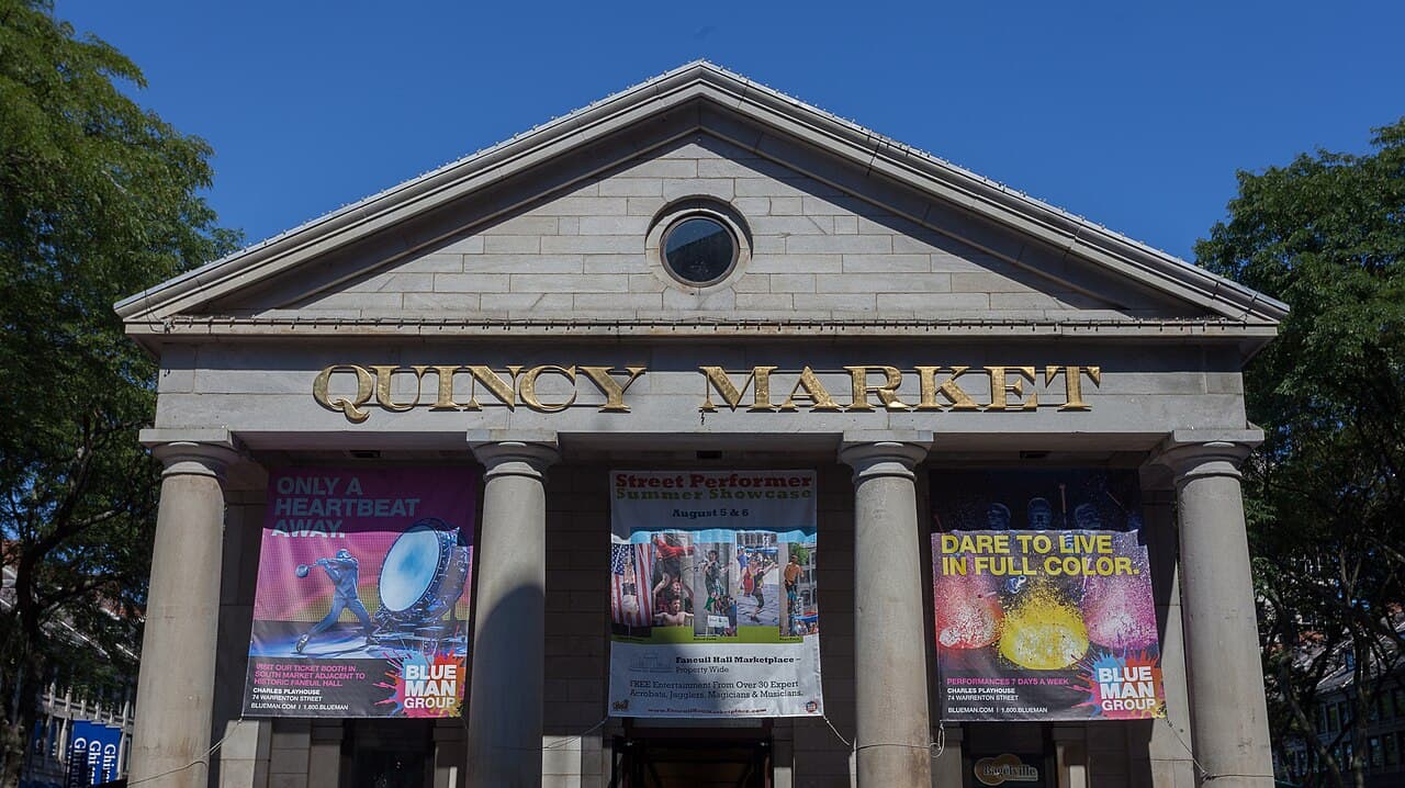 The columned front of Quincy Market at Faneuil Hall Marketplace in Boston, with its name in gold letters